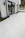 Modern smart home exterior with controlled access and sleek 60x1.20 rectified flooring visible through large windows.