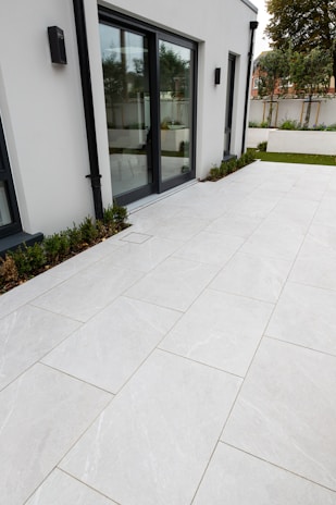 A happy family standing proudly outside their house, featuring a sleek new sliding door.