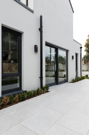 Exterior view of an industrial building with waterproofed terrace and clean surrounding green spaces.