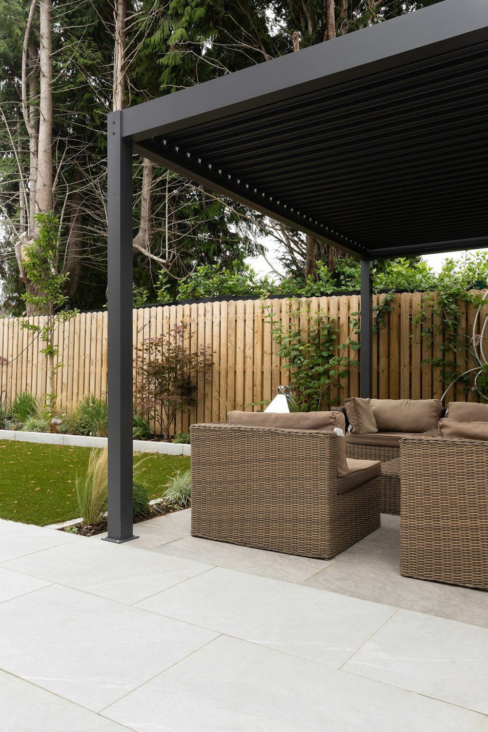 a covered patio with a couch and chairs