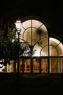 Commercial building exterior lit by elegant, well-placed outdoor lighting fixtures.