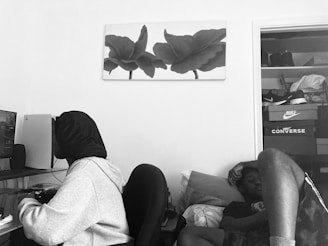 A cozy workspace with a gamer enjoying a rented console and a student using a laptop side by side.