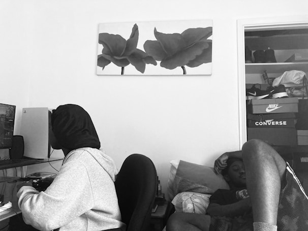 A cozy workspace with a gamer enjoying a rented console and a student using a laptop side by side.