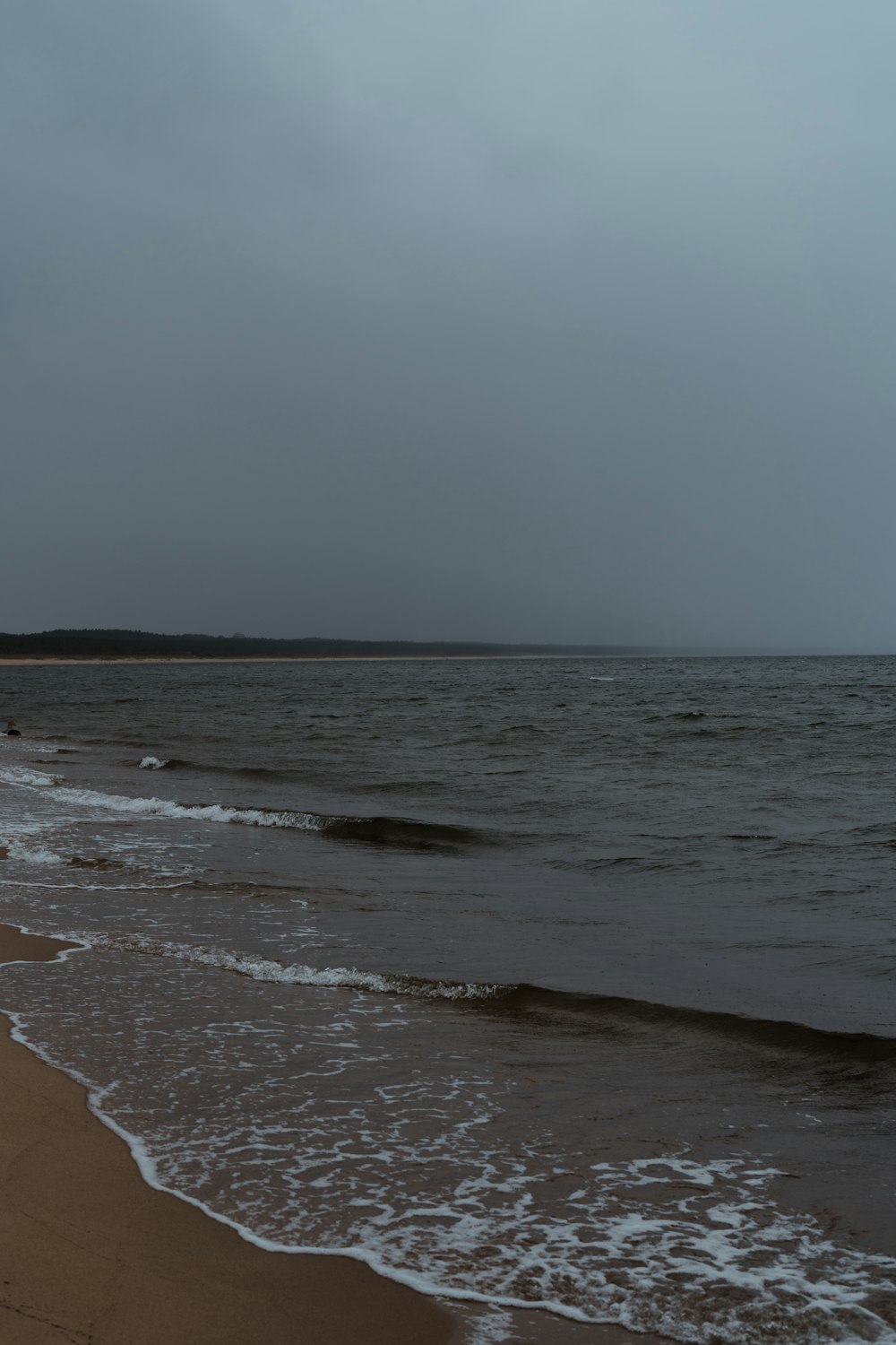 a beach with waves coming in to shore