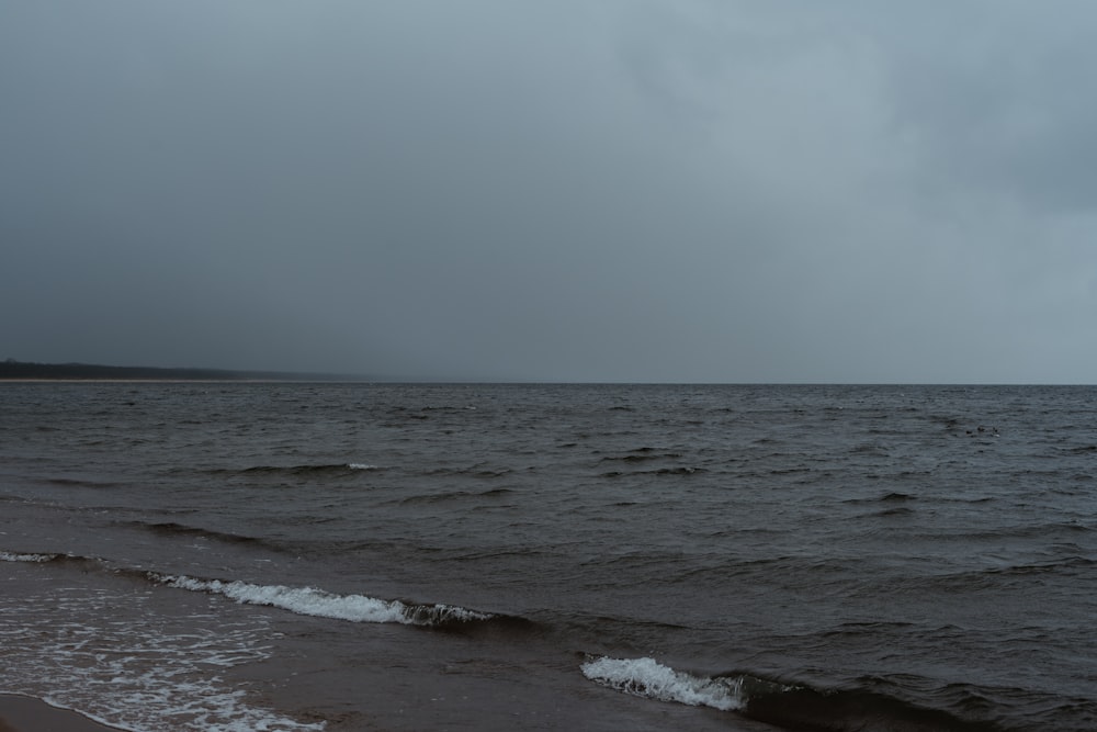 a body of water with waves coming in to shore