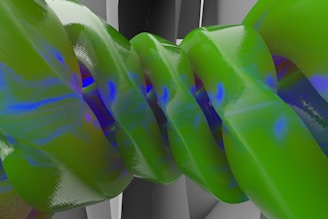 A complex abstract design featuring intertwined, glossy green and blue ribbon-like structures with a reflective surface. The background appears to be a soft gray gradient, enhancing the vibrant colors of the ribbons.