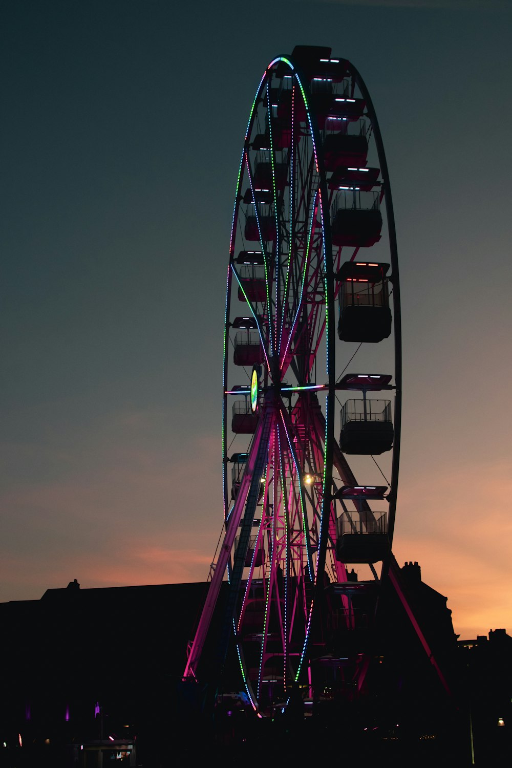 a ferris wheel is lit up at night