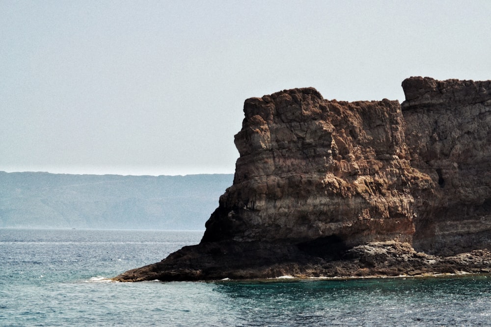 a rock outcropping in the middle of the ocean