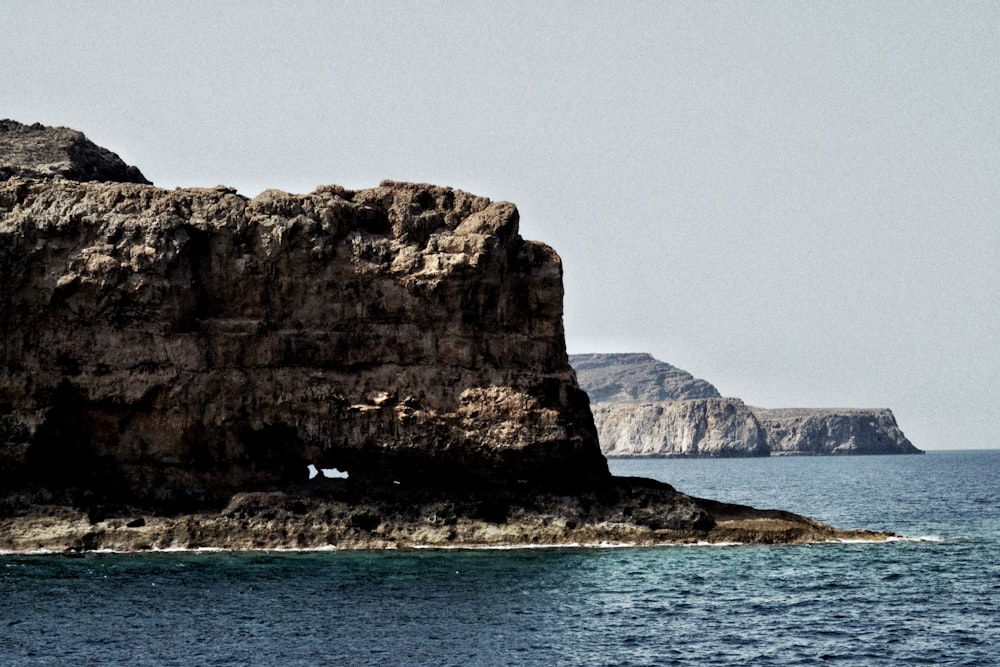 a rock outcropping in the middle of the ocean