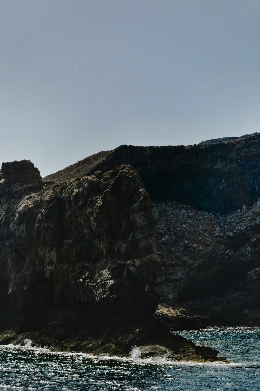 a large rock sticking out of the ocean