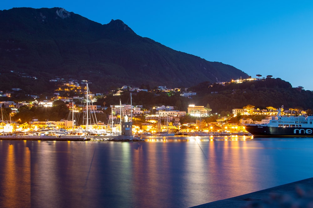 a boat is docked in a harbor at night