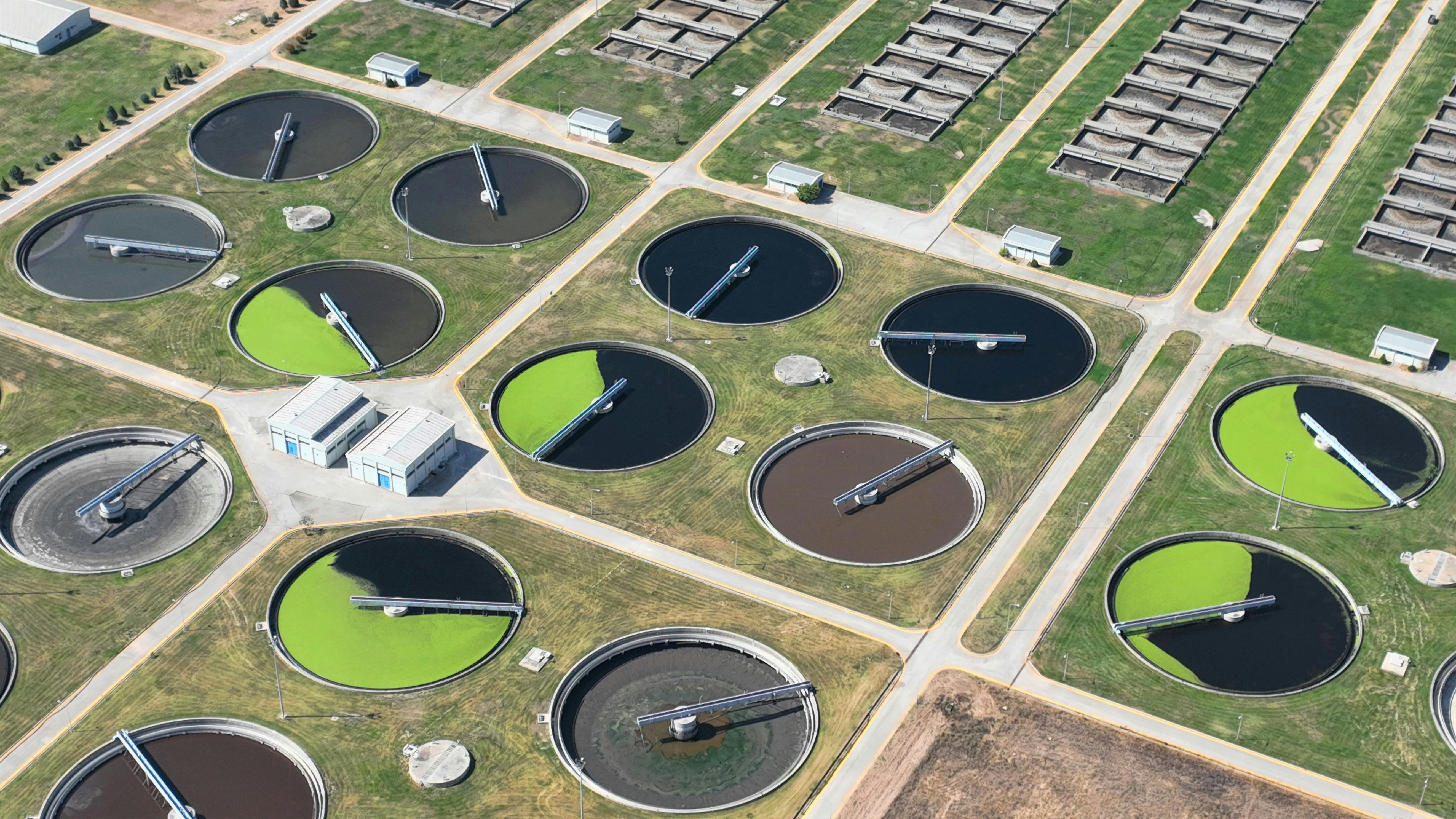an aerial view of a field with a lot of water tanks