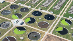 an aerial view of a field with a lot of water tanks