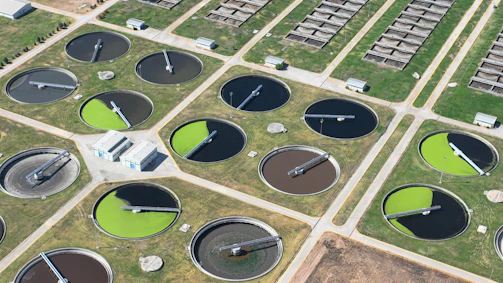 an aerial view of a field with a lot of water tanks