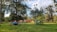 A happy family setting up a tent in a scenic campsite.