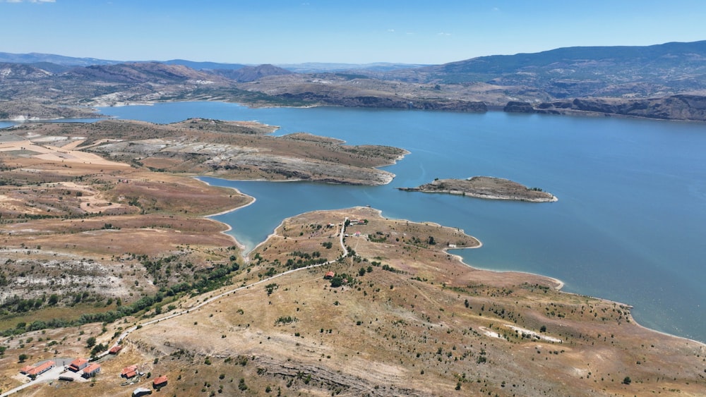 an aerial view of a lake surrounded by mountains