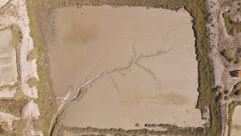 an aerial view of a field with a dirt road