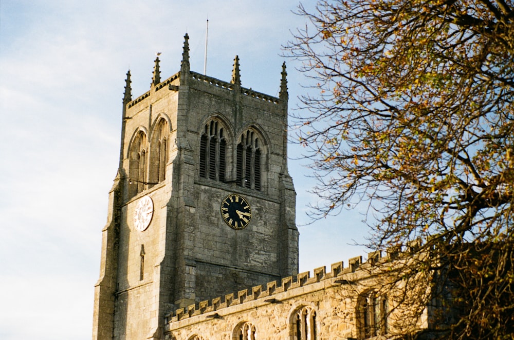 a large stone building with a clock on it's side