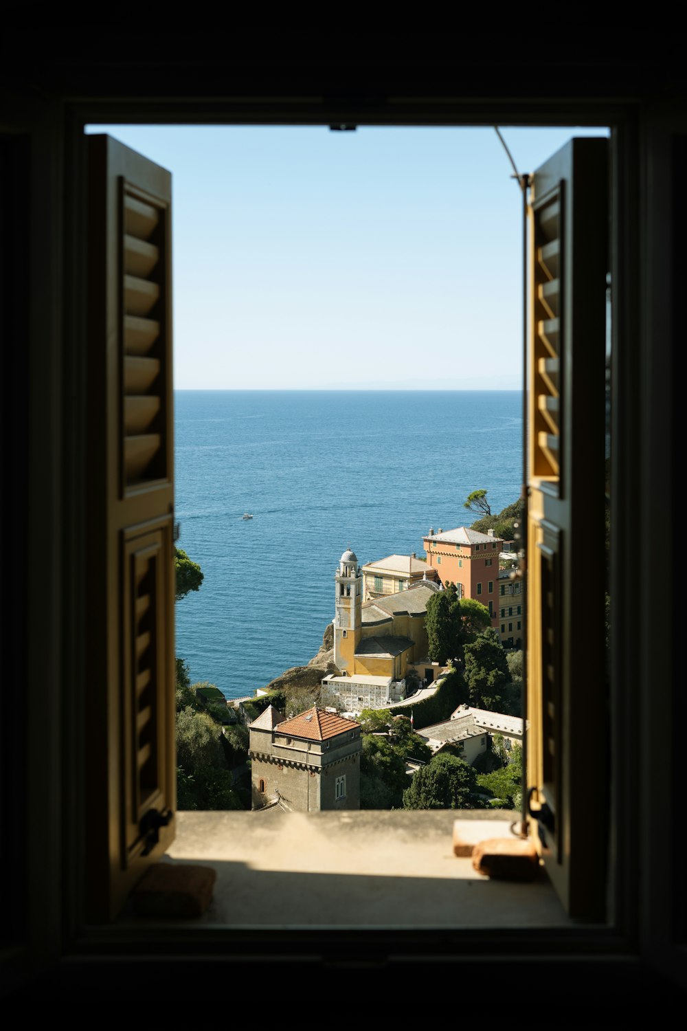 a view of the ocean from an open window