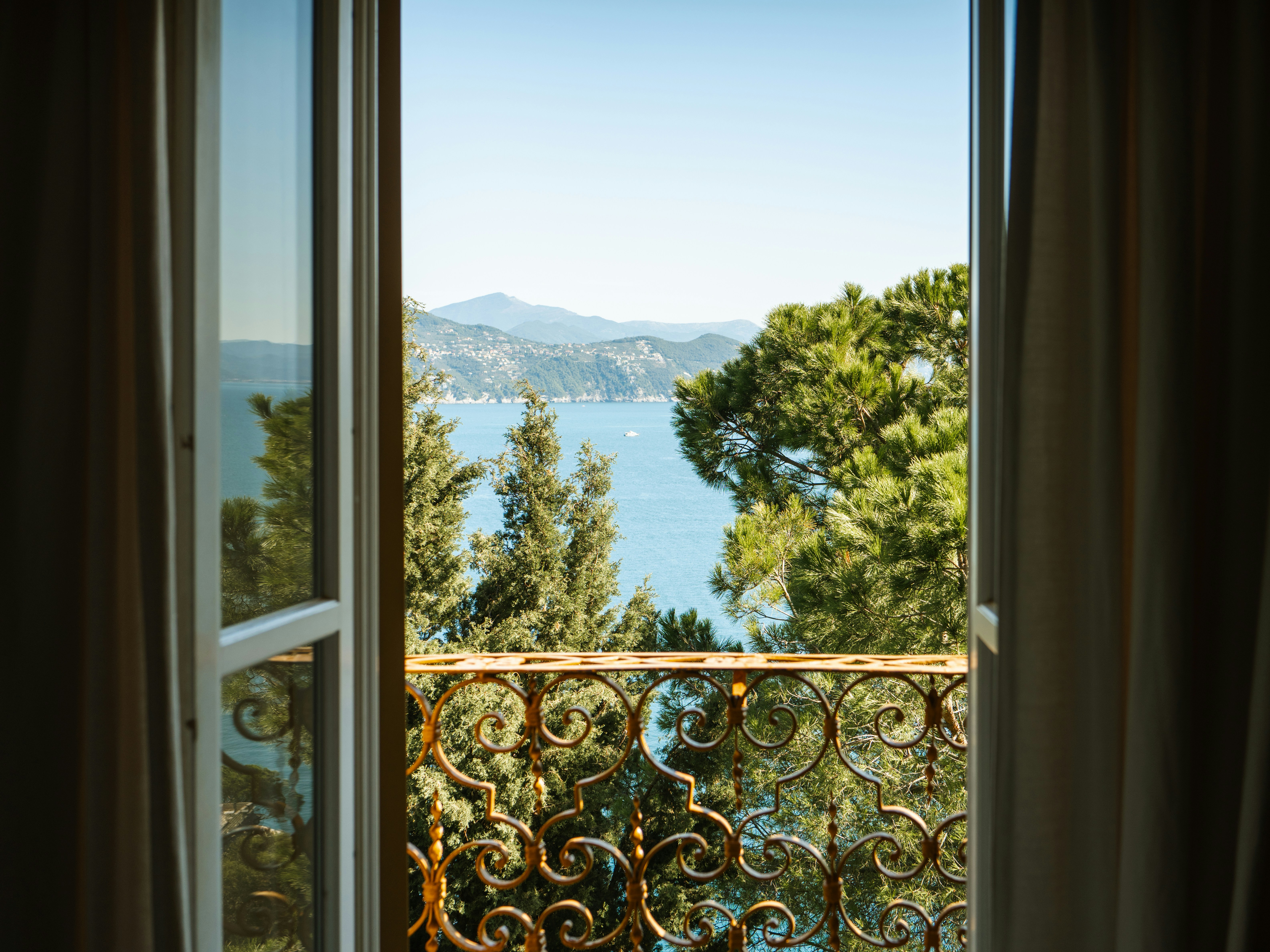 an open window with a view of a body of water