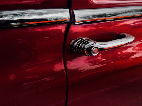 Close-up of a restored vintage refrigerator with a shiny chrome handle.