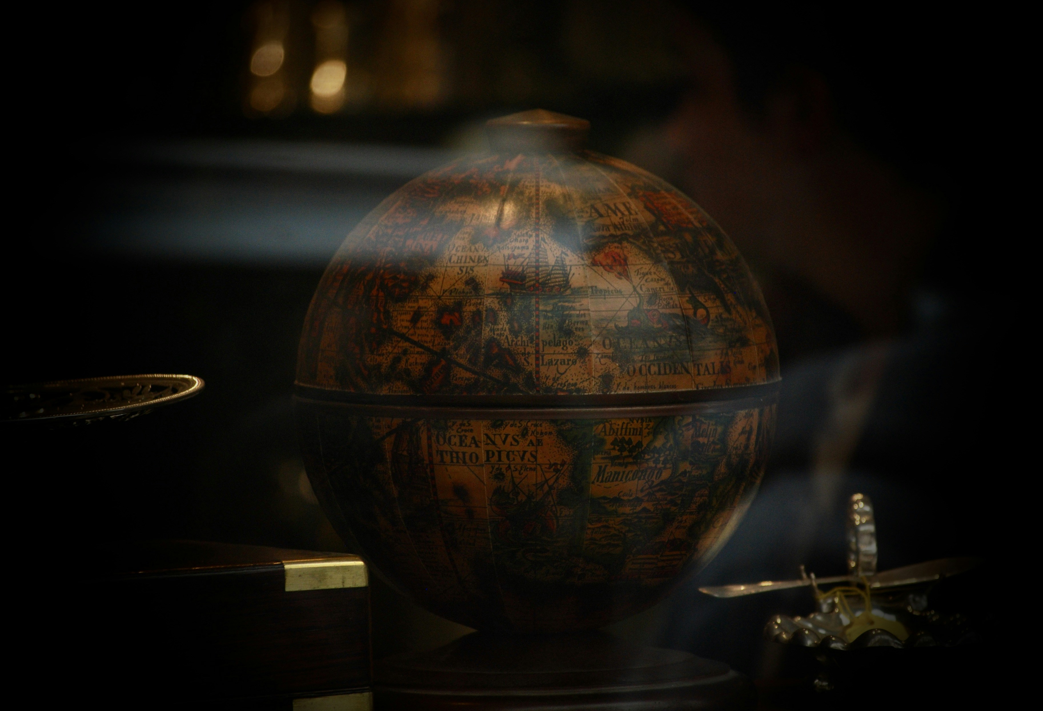 a globe sitting on top of a wooden table, 