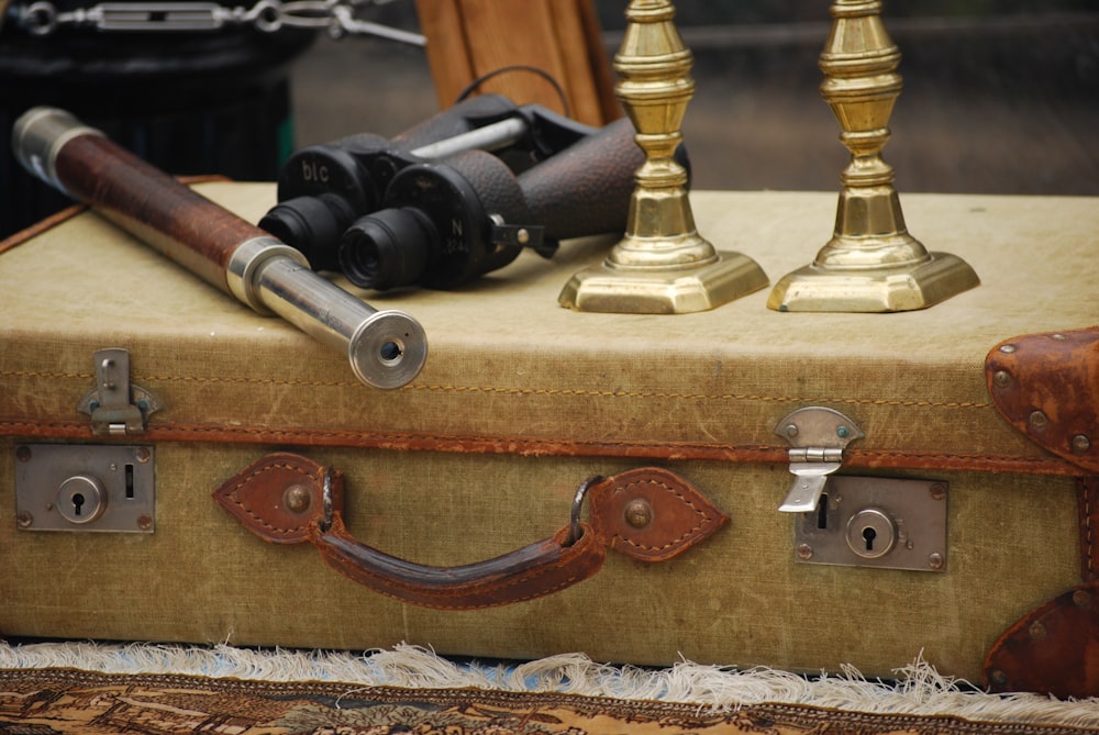 a suitcase with a telescope on top of it