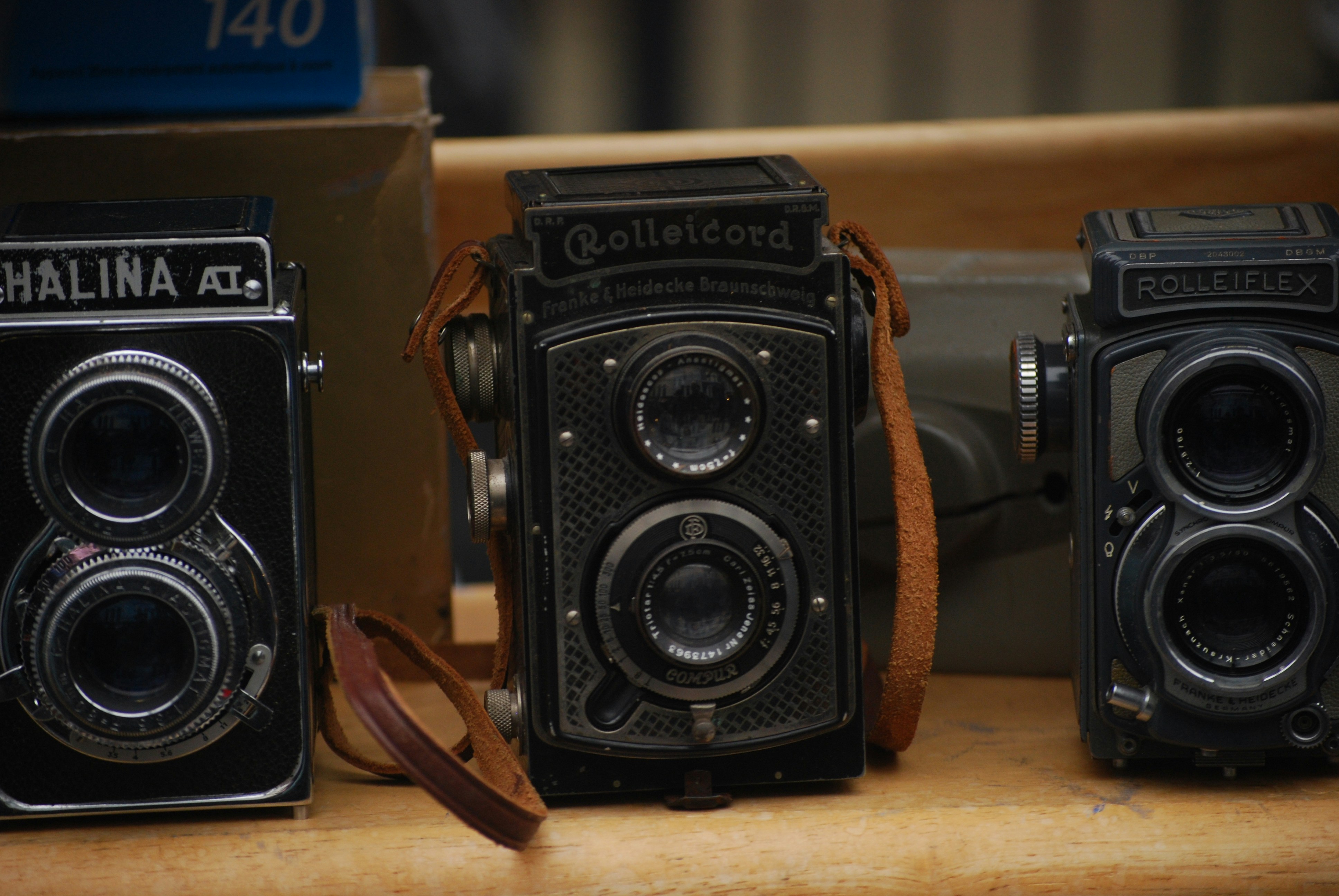 three old cameras are sitting on a table
