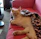 A cute cat lounging on a cozy sofa wearing a stylish, handmade pink hoodie.