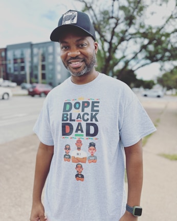 A dad wearing a custom photo t-shirt while playing with his kids in the park.