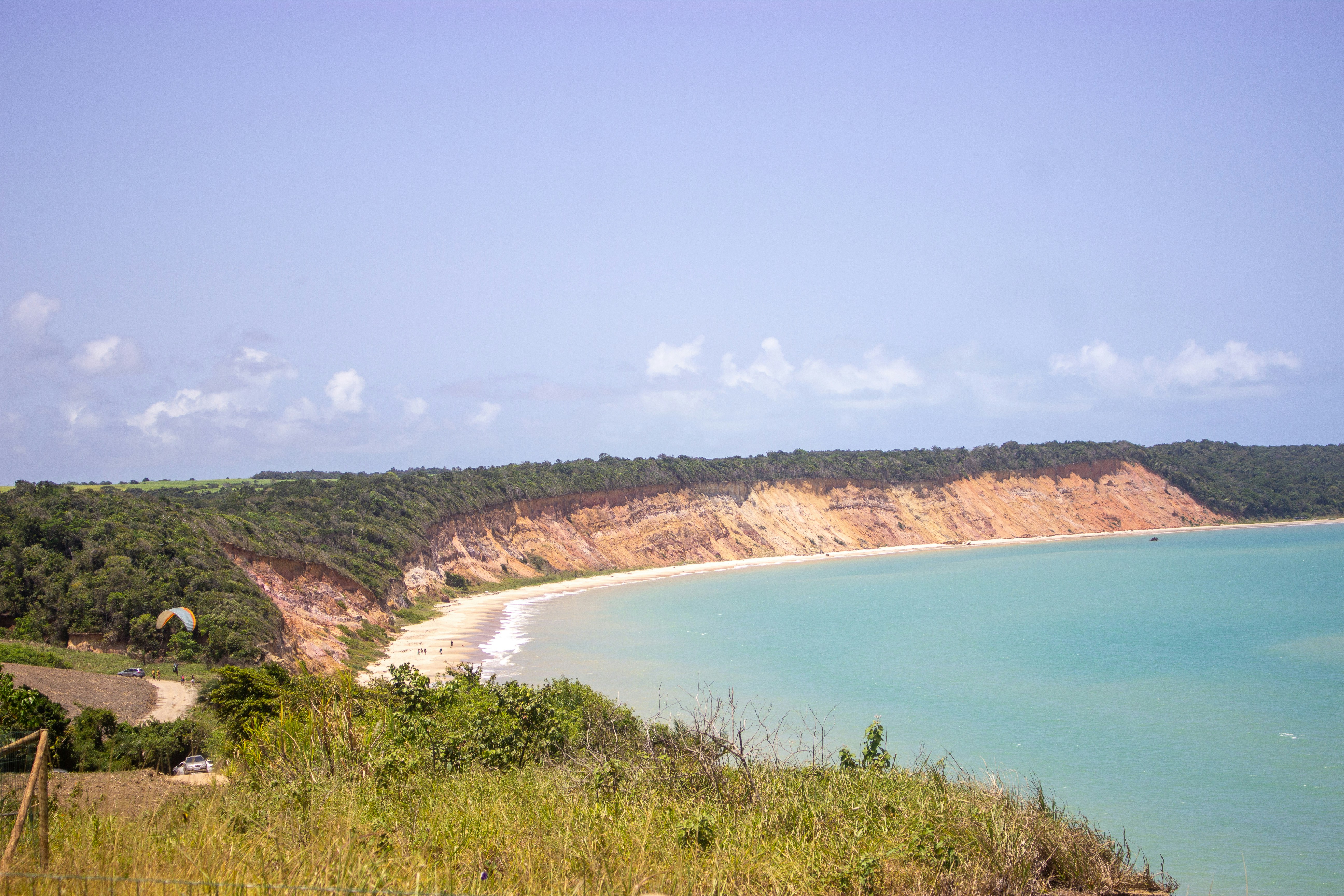 a view of a beach with a cliff in the background