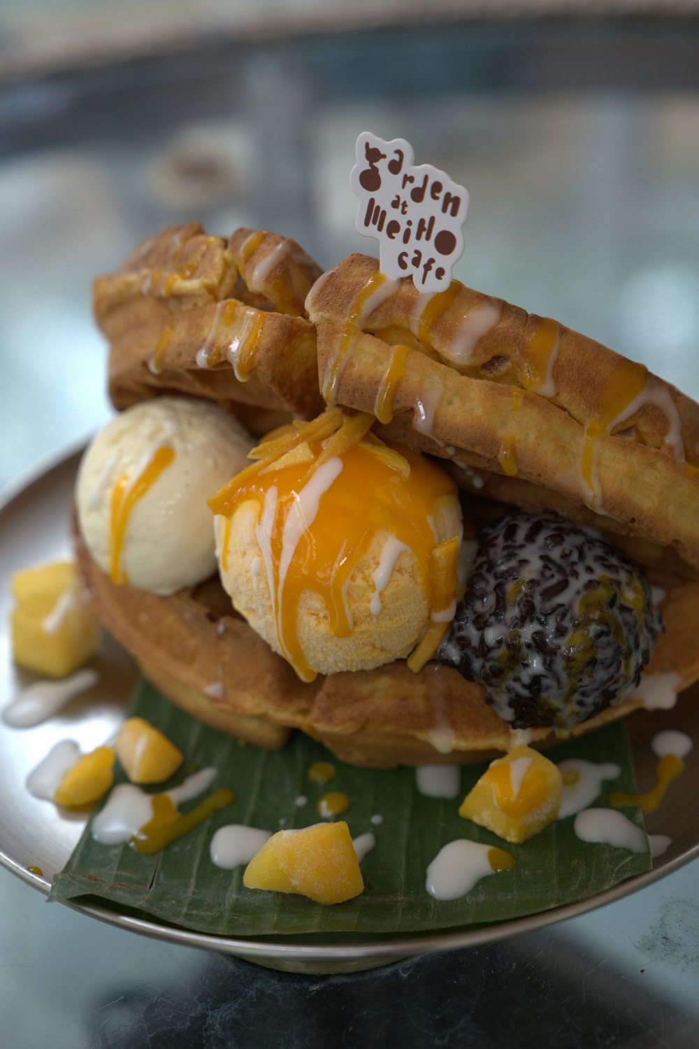 a plate of food that includes waffles and ice cream