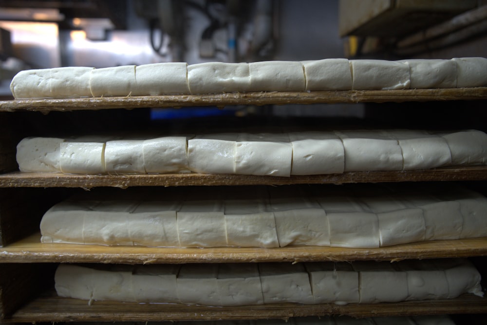 a bunch of bread that are on a shelf