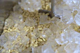 Artistic shot of frozen fruit cubes arranged on a chilled surface with soft natural light.