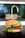 A close-up of a gourmet cheeseburger placed on a dark surface. The burger consists of a whole grain seeded bun, melted cheese, a beef patty, fresh tomato slices, and leafy greens. The background shows a slightly blurred kitchen faucet and sink area.