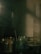 A dimly lit laboratory or scientific setting featuring various glassware and beakers. A tall graduated cylinder partially filled with liquid can be seen in the background, with reflections and shadows creating a moody ambiance.