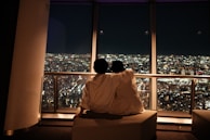 Candid portrait of a couple sharing a quiet moment on a city bench.