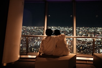 Candid portrait of a couple sharing a quiet moment on a city bench.
