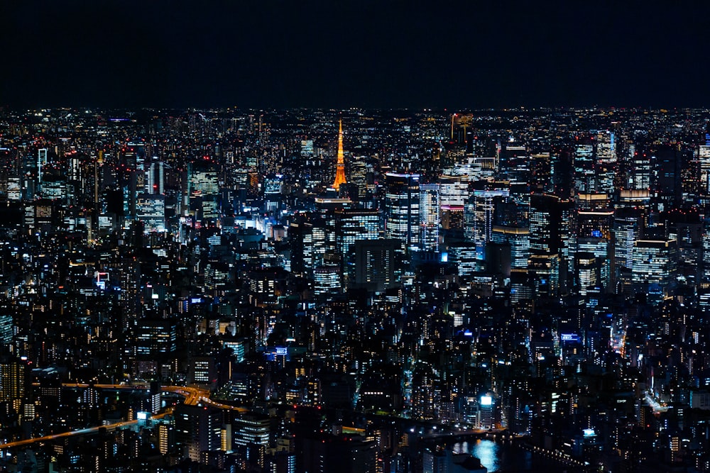 a view of a city at night from the top of a skyscraper