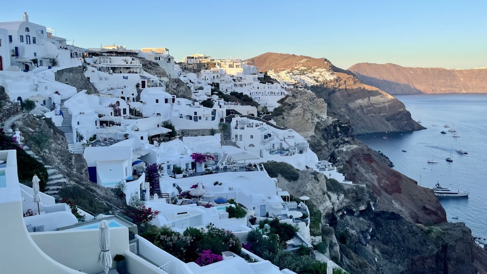 a view of a village on a cliff overlooking the ocean