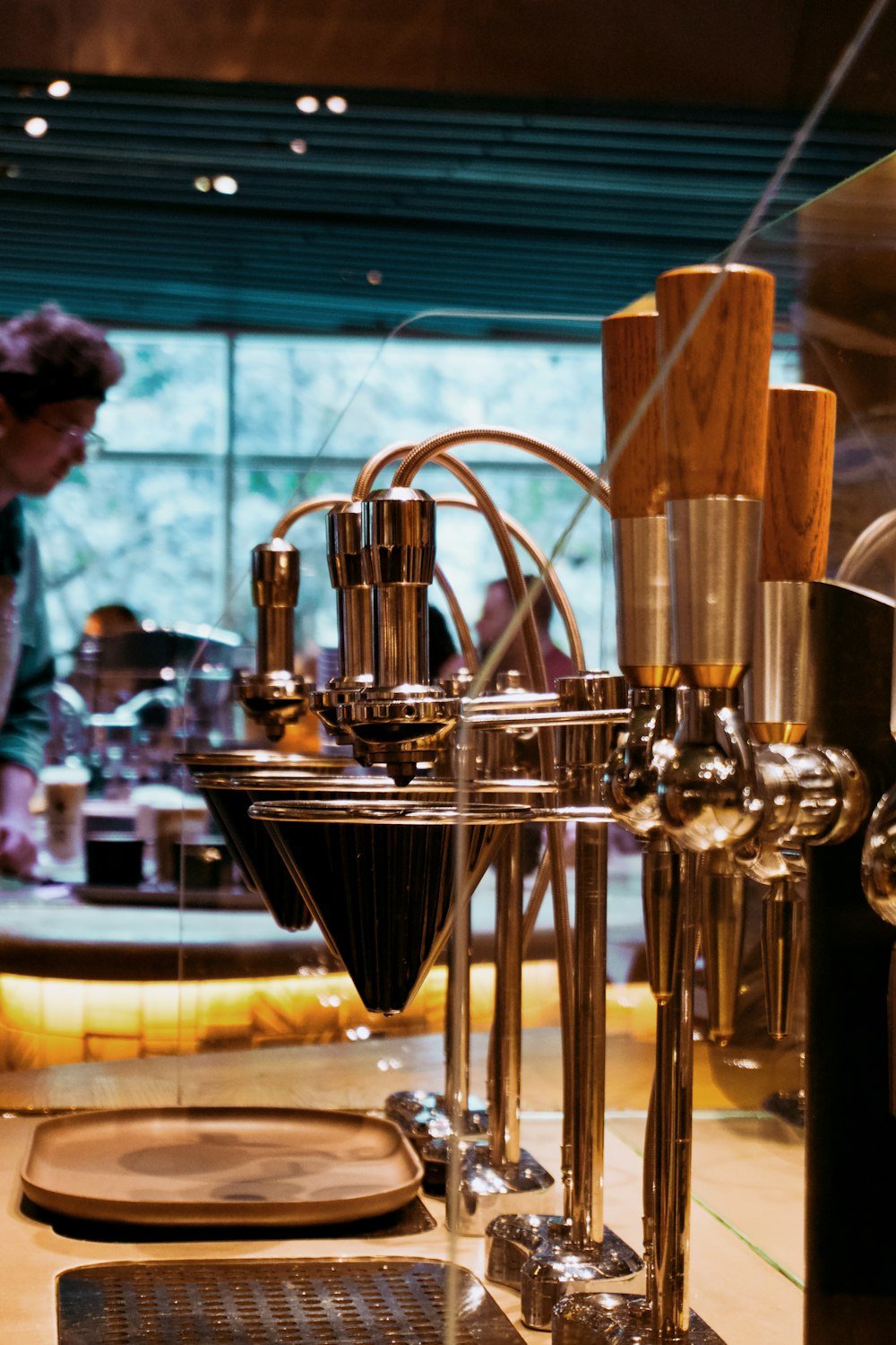 a coffee machine with a person in the background