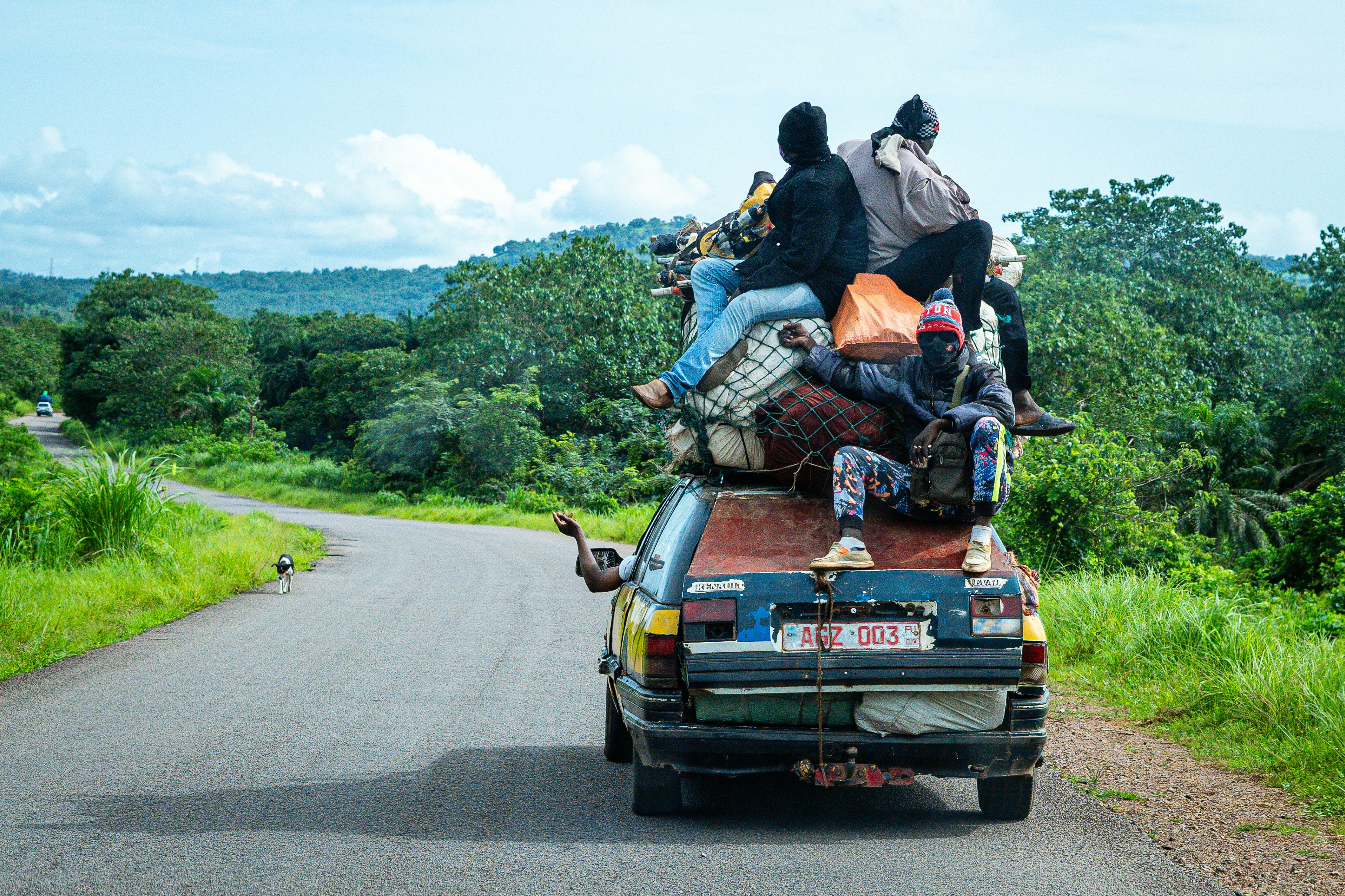 a group of people sitting on the back of a truck