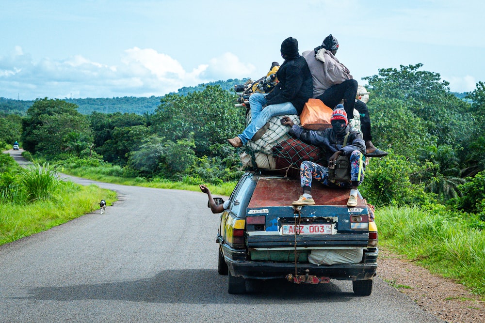 a group of people sitting on the back of a truck