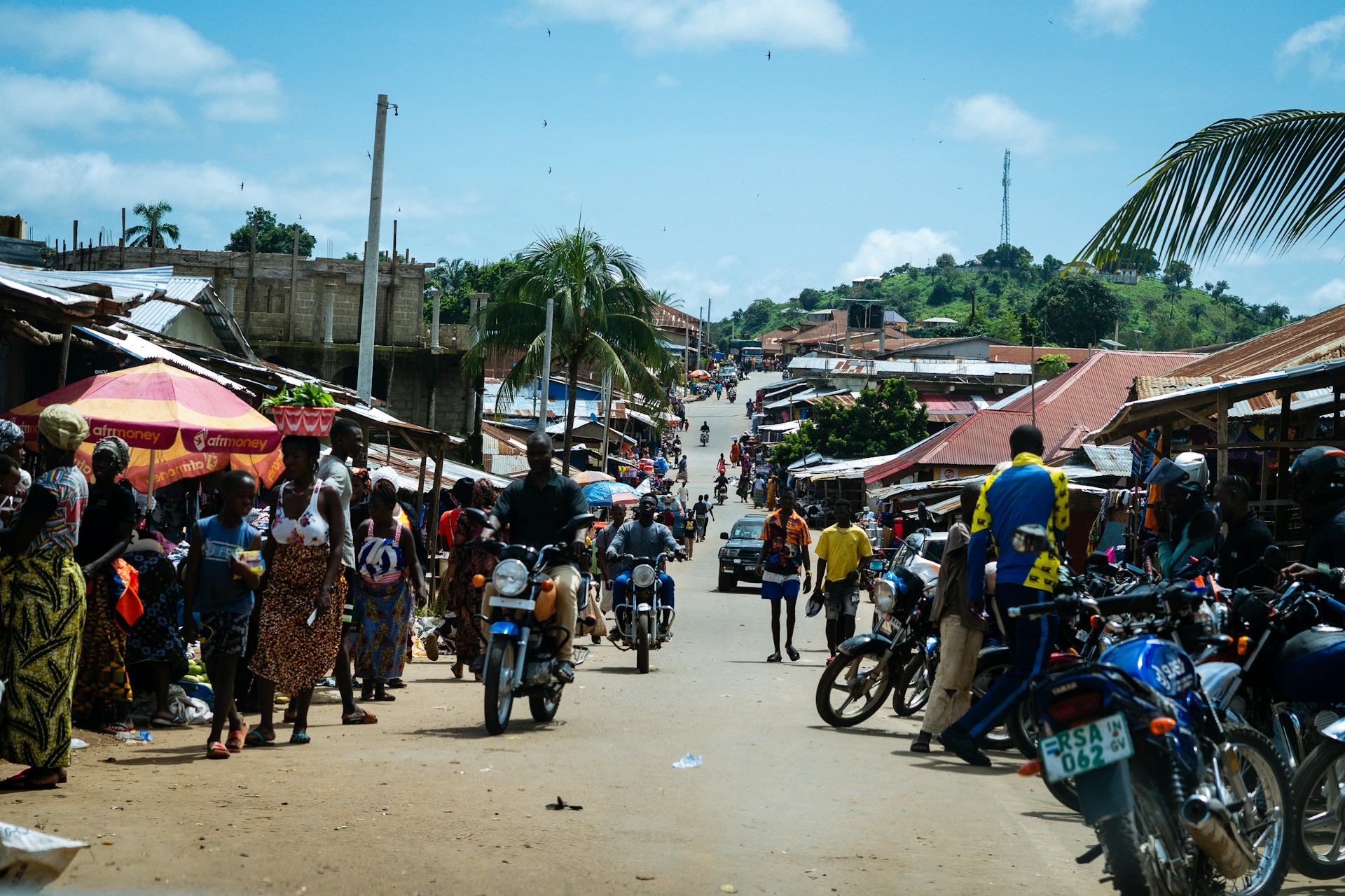 a group of people riding motorcycles down a street