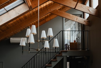 a chandelier hanging from a wooden ceiling
