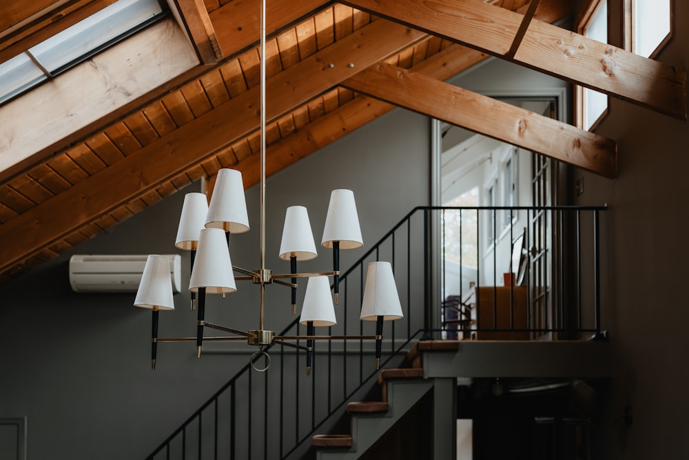 a chandelier hanging from a wooden ceiling