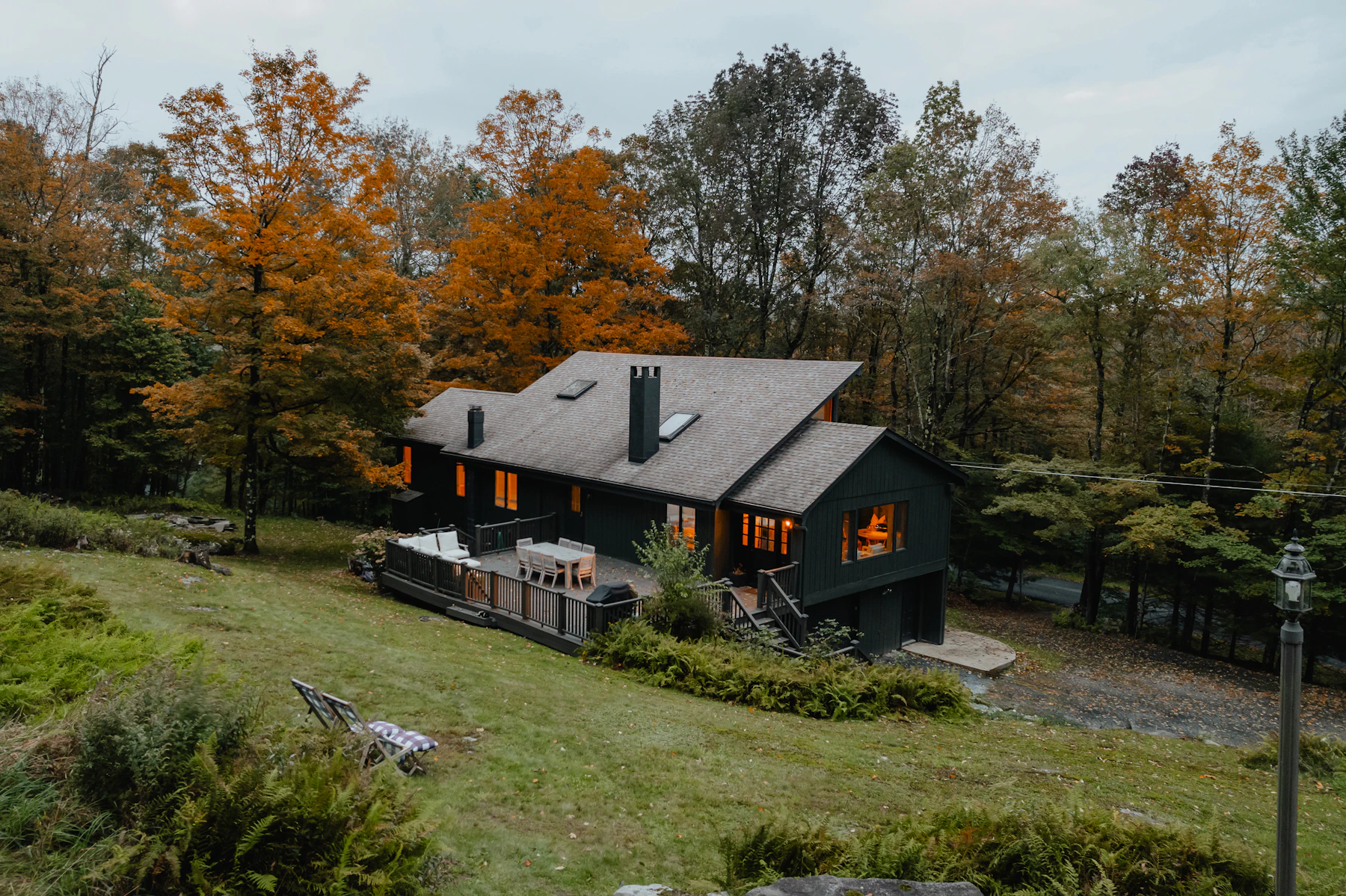 Private cabin surrounded by trees with an outdoor hot tub
