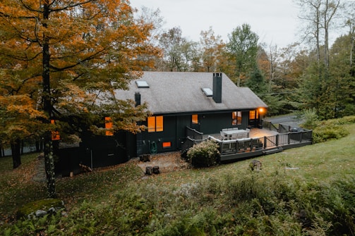 A cozy Minnesota home nestled among trees, representing the kind of residential properties Guzek Investments offers.