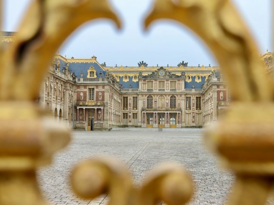 The château through the gilded gate — Versailles, France