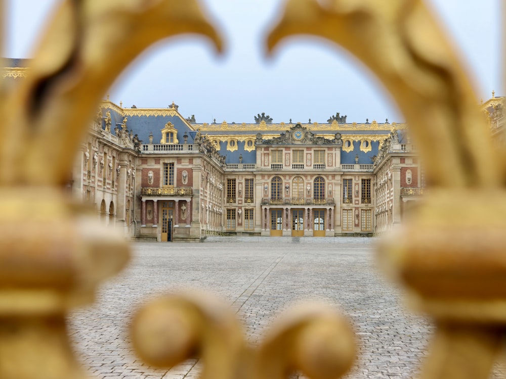 a view of a large building through a gate